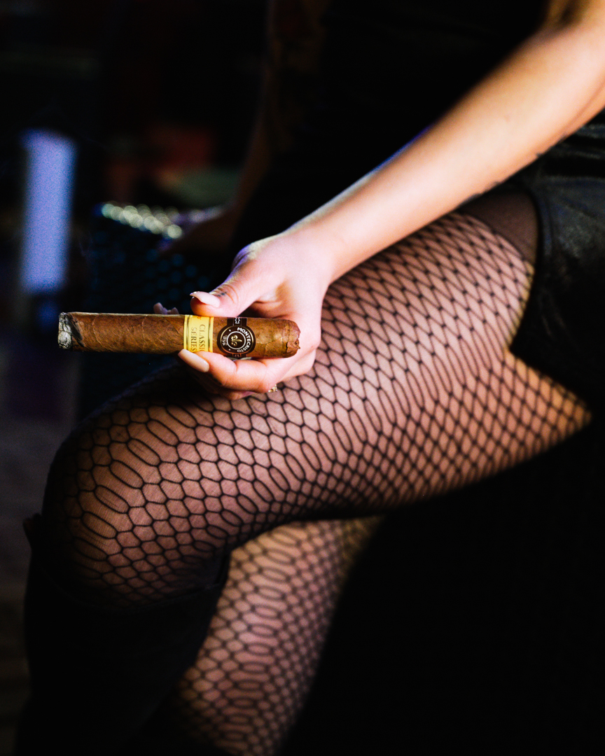 Woman holding cigar at Flute & Dram