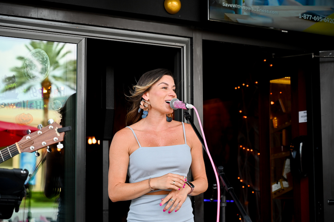 Singer in gray dress at Flute & Dram on Beach Drive in St. Petersburg, Florida
